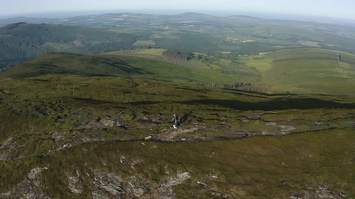 Aerial view of couple hiking mountains summer. Hikers walking. Sports recreation activity. Summer ho