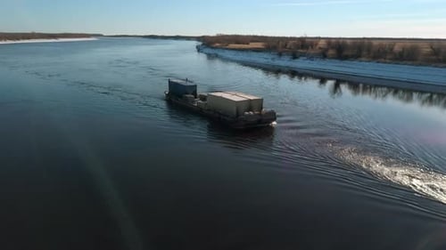 Top view of barge floating with cargo on river