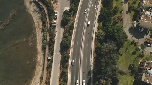 High angle aerial static shot of road near the coastline