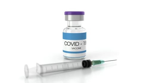COVID-19 Vaccine Vial and Syringe on White