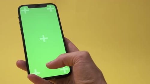 Woman Hand with Smartphone with Blank Green Screen Screen Touch Copy Space for App or Website Design