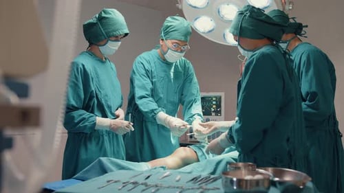 assistants and nurses performing invasive surgery on patient in hospital operating room.