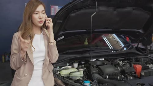 Woman Talking on Phone at Car Repair Shop