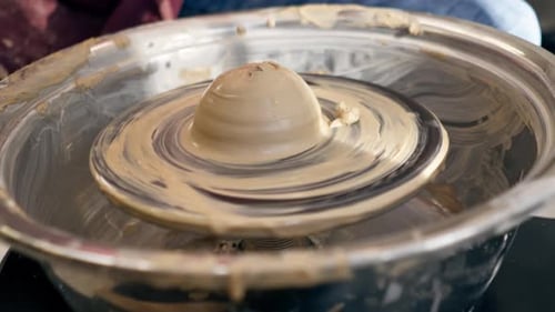 Close Up the Clay Modeling Studio Young Girl Hands Giving Shape to Clay on a Potter's Wheel Applied