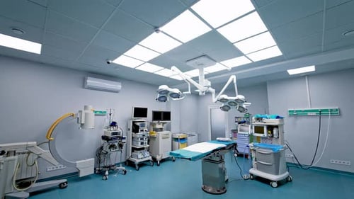 New modern surgery room with no people in it. White operational ward with table in the middle