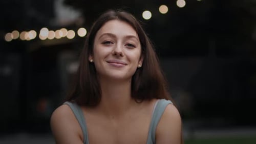 Close-up attractive girl woman outdoors smiling looking at camera, happy