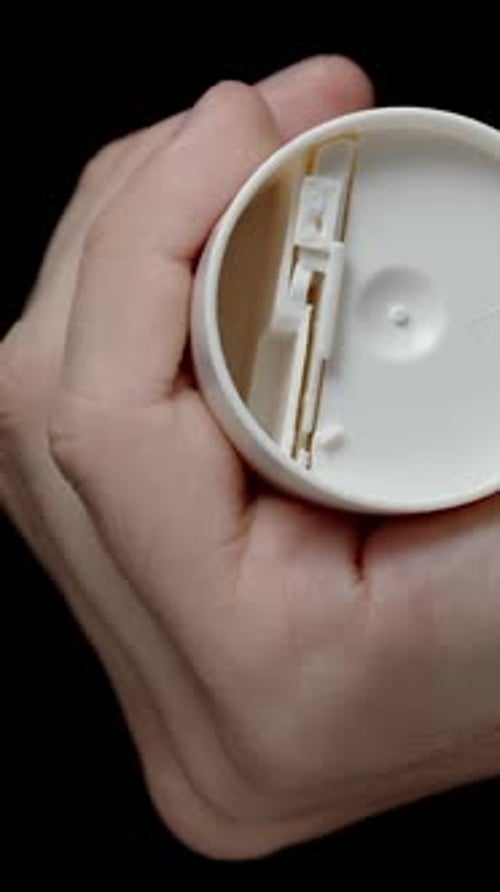 Vertical video. Container Dispenser with Sugar Substitute. Artificial Sweetener. Tablets Fall Down.