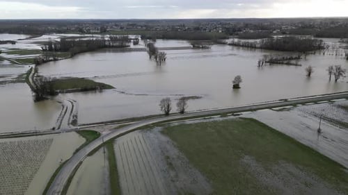 Aerial view of flooded fields near road, France.