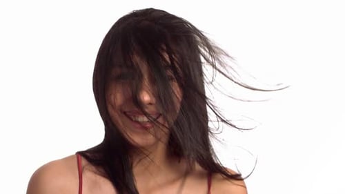 Smiling Woman with Windblown Hair on White Background