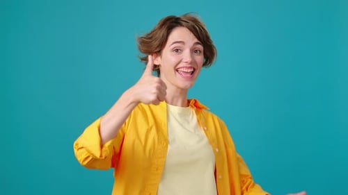 Smiling Brunette Woman Gives Two Thumbs Up
