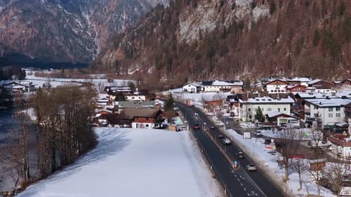 Top Down View of Cars Driving on a Mountain Road Through Snowy Town of Saalbach in the Austrian Alps