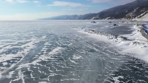 Aerial view of frozen lake and mountains, Russia.
