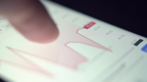 Businessman Uses a Smartphone to Check the Price of Bitcoin on a Trading Market