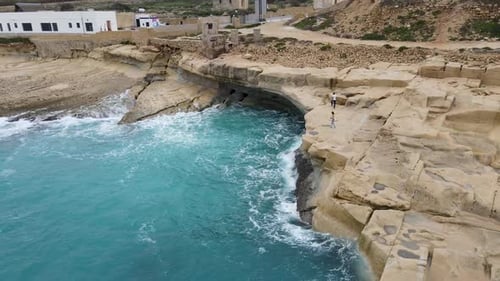 Aerial panoramic view of seascape and natural rock formations in Malta. Agitated azure sea with stor
