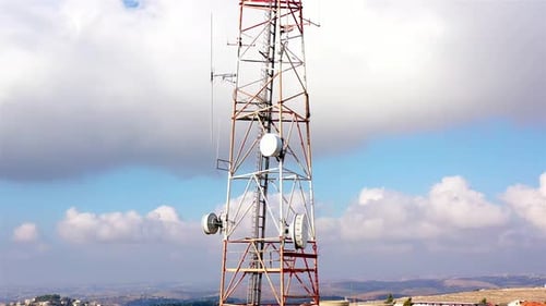 Aerial footage Close to cellular Antenna with blue sky and Clouds