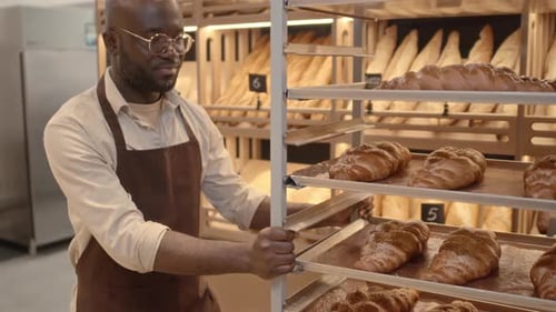 Bakery Salesman Carrying Fresh Bread on Tray Rack