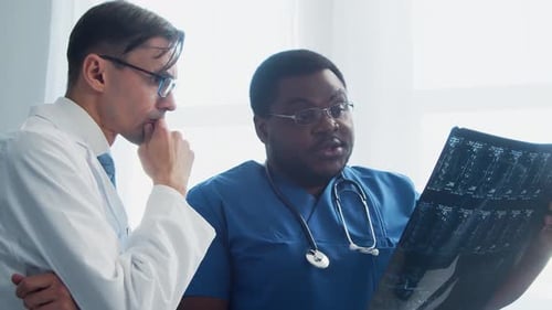 Doctor and Surgeon Talking Near Window Medical Workers in Hospital Office Day Light Healthcare