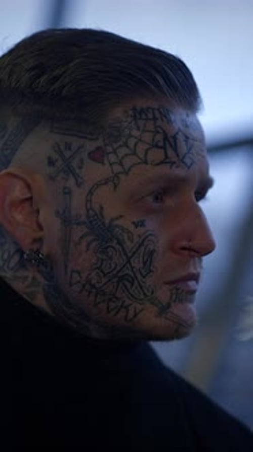 Intricate Facial Tattoos Adorn a Stylish Individual Showcasing Artistry and Creativity