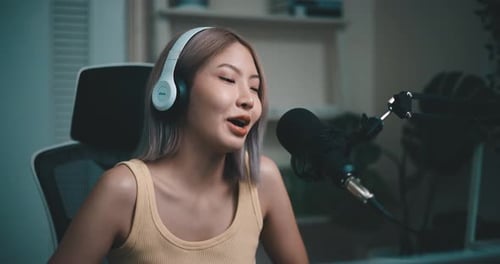 Woman Talking Into Microphone Wearing Headphones