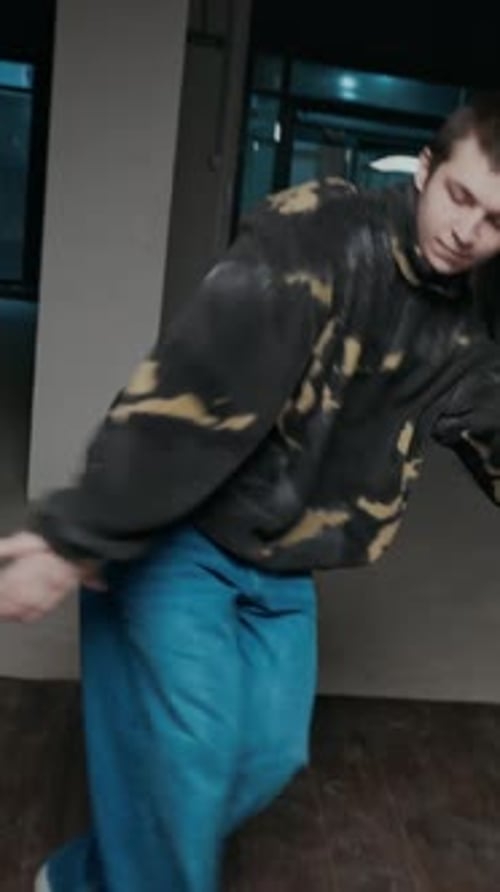 Young Adult Showing Energetic Dance Moves Indoors