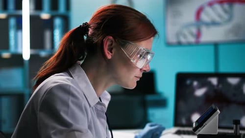 Scientist Works with Lab Equipment in Blue Light