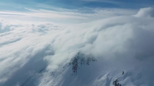 Alpine Landscape with Peaks Covered By Snow and Clouds