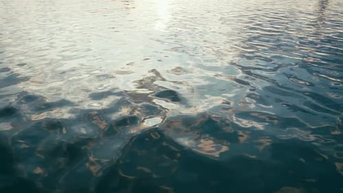 Blue sea water with sky reflection. Slow motion restless excitement on sea surface