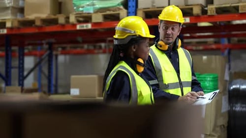 Warehouse Industrial and Logistics Companies. Dispatcher in uniform making inventory in storehouse.