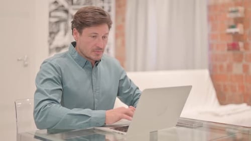 Man Working at Laptop in Modern Home