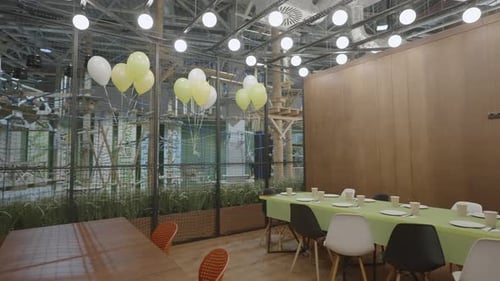 A Contemporary Dining Space Beautifully Enhanced with Green Decor and Cheerful Balloons Creative