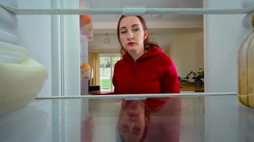 Woman Opening Fridge Regretfully Looking at Empty Shelves and Sighing View From Inside of Fridge