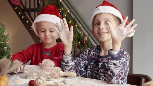 Two Children Baking Cookies for Christmas