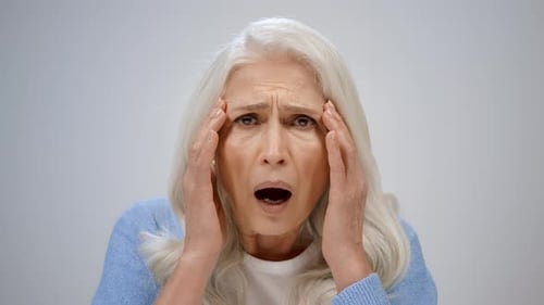 Senior Woman Experiencing a Headache or Stress