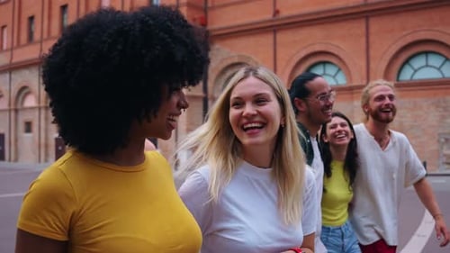 Group of Cheerful University Friends Walking Down the Street Smiling and Laughing