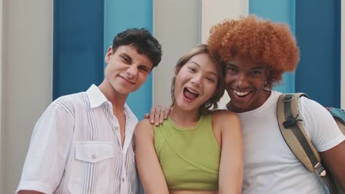 Three Friends Smiling Cheerfully at Camera Close Up
