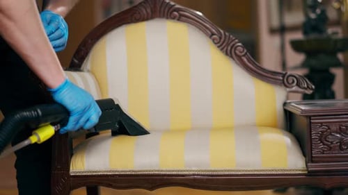 Close Up Professional Cleaning of an Apartment Cleaner Wets the Console Before Washing