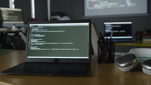 Laptop with Computer Code on Screen at Programming Lesson