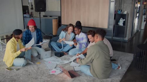 Diverse Young Professionals Discuss Ideas in Modern Office