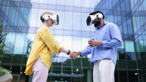 People Using VR Headsets Shaking Hands in Urban Setting