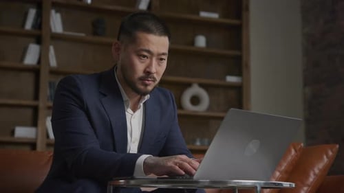 Adult Man Working on Laptop Indoors