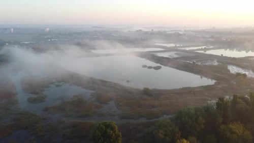 Foggy Sunrise Over Lakes Near City