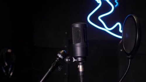 Studio condenser microphone, on background of neon pattern in blue.