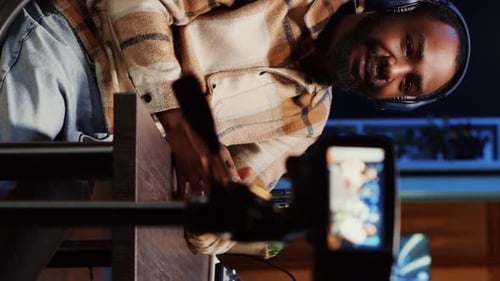 Young Adult Broadcasting with Microphone and Headphones