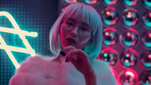 Stylish Woman with Blonde Bob Posing in Neon Lighting