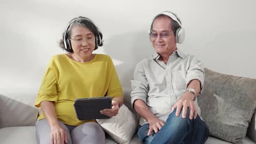 Relaxing Senior Couple Listening to Tablet Together