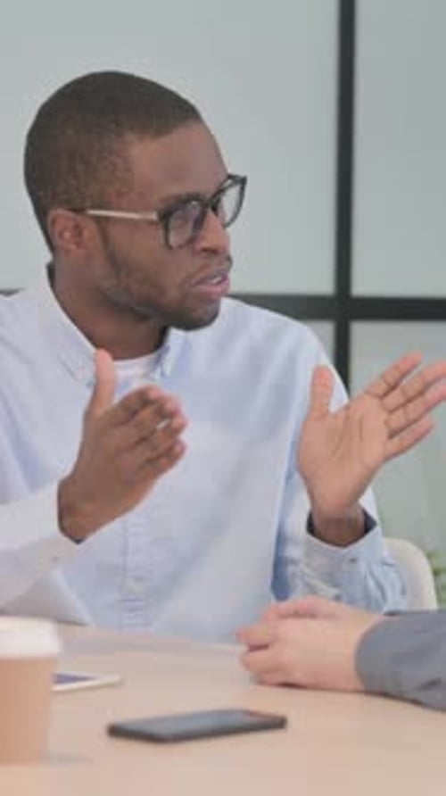 Man Talking in Office Meeting, Explaining with Hands