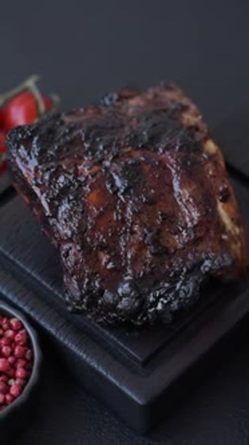 Grilled or barbecued pork or beef ribs, meat with red sauce for the dinner table. Grilled ribs