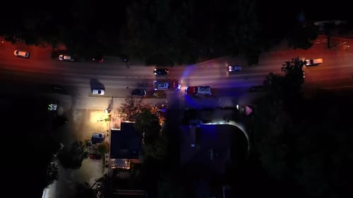 Aerial shot of a fire brigade blaring horn and rushing through traffic. Fire trucks