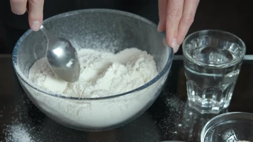 Mixing White Flour in a Bowl with Spoon