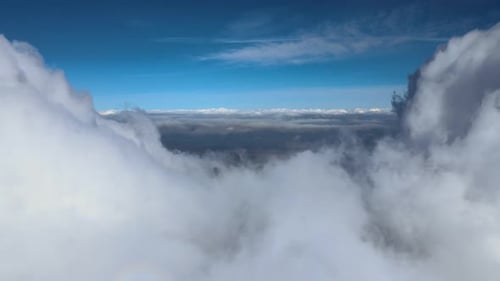 Aerial View From Airplane Window at High Altitude of Earth Covered with Puffy Cumulus Clouds Forming